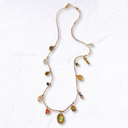 Multi charm woven string necklace