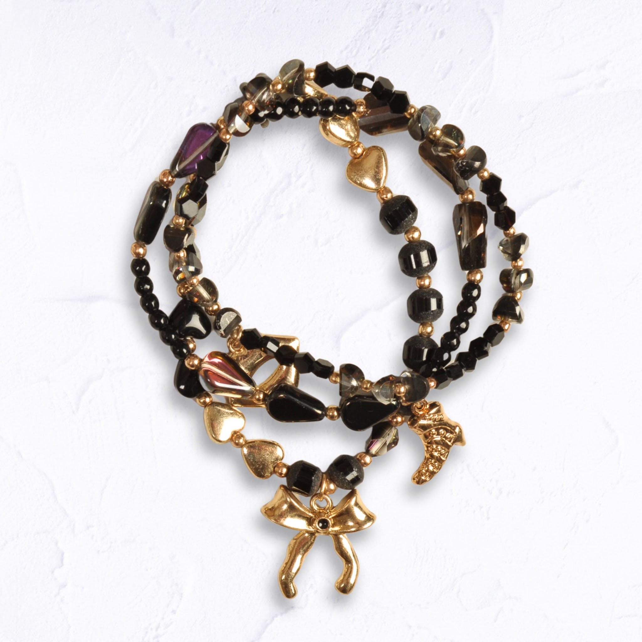 Bow charm multi string beaded bracelet